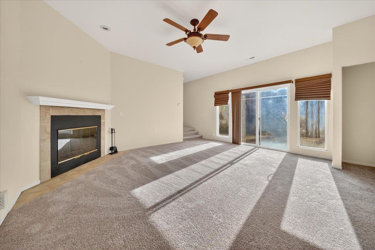 1282 Hamilton Avenue Seaside, CA 93955 - Photo 14 of 45 a view of an empty room with a fireplace and a ceiling fan