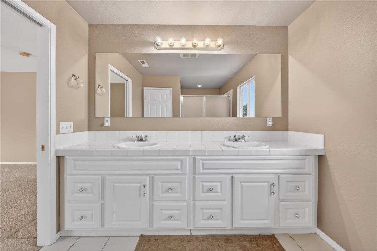 1282 Hamilton Avenue Seaside, CA 93955 - Photo 21 of 45 a bathroom with a double vanity sink and a mirror