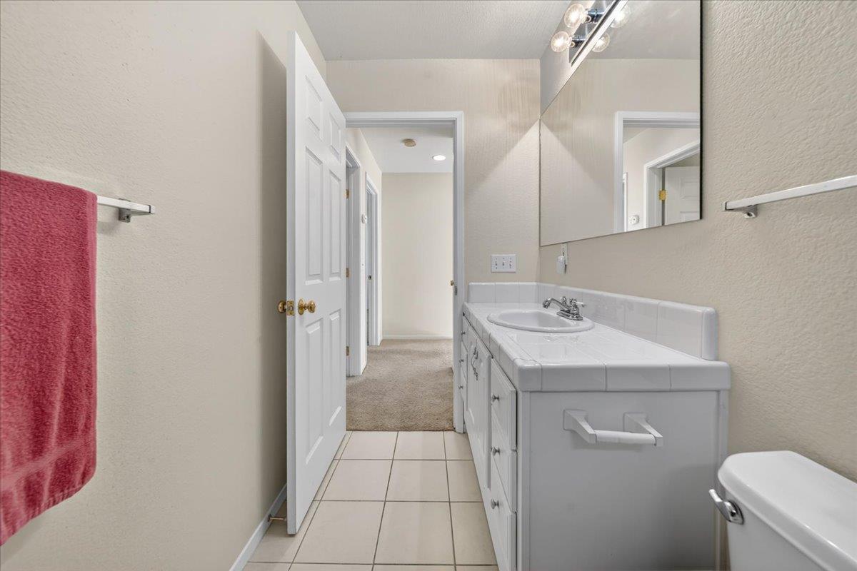1282 Hamilton Avenue Seaside, CA 93955 - Photo 27 of 45 a bathroom with a sink a toilet and a mirror