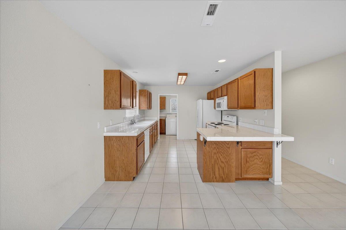 1282 Hamilton Avenue Seaside, CA 93955 - Photo 5 of 45 a large room with kitchen island a sink a stove and a microwave oven