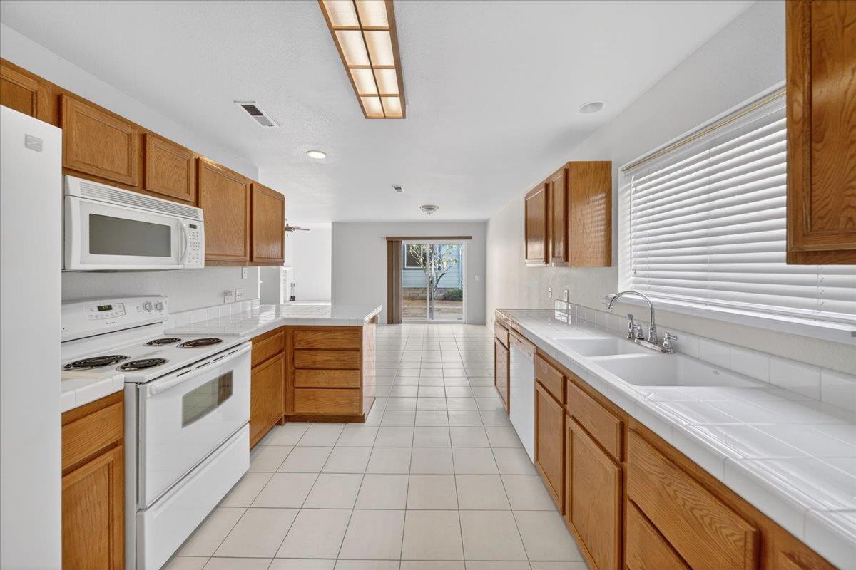 1282 Hamilton Avenue Seaside, CA 93955 - Photo 6 of 45 a large kitchen with stainless steel appliances granite countertop a sink and a stove