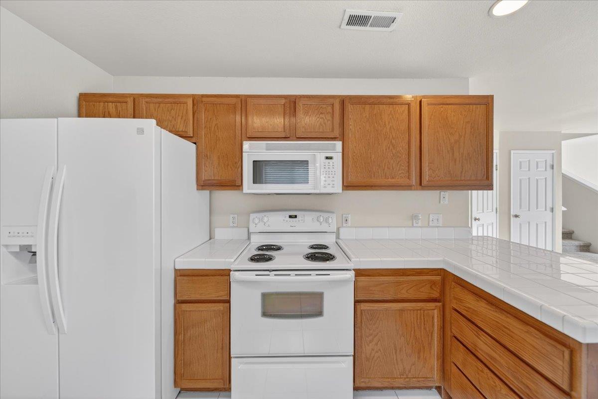 1282 Hamilton Avenue Seaside, CA 93955 - Photo 7 of 45 a kitchen with a white stove top oven and sink