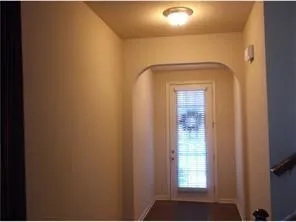 a view of a hallway with a window