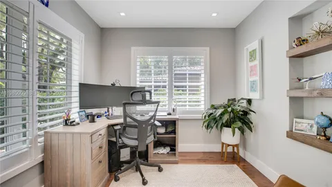 a view of a workspace with furniture and a potted plant