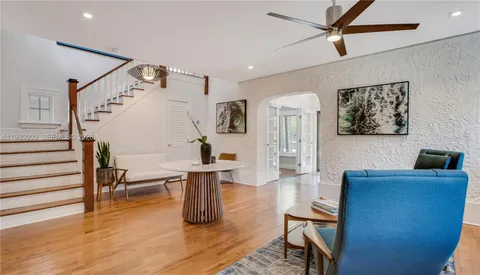 a living room with furniture and a wooden floor