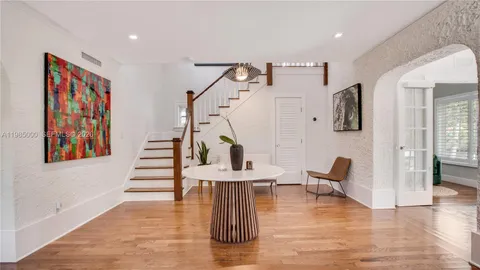 a view of entryway and hall with wooden floor