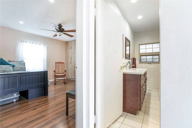 a bathroom with a sink a vanity and a large mirror
