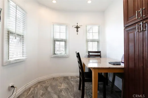 a large kitchen with stainless steel appliances granite countertop a stove a sink and a microwave