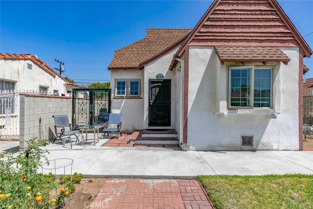 a front view of a house with sitting area