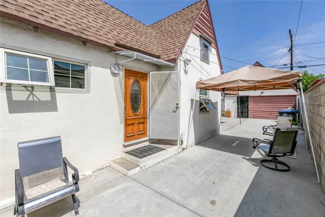 a building outdoor space with patio furniture and potted plants
