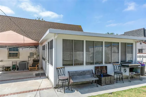 a view of a house with backyard and sitting area