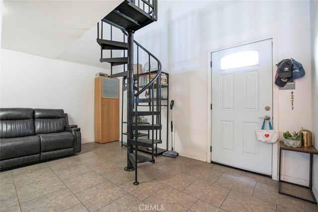 a kitchen with stainless steel appliances kitchen island granite countertop a refrigerator and a stove top oven