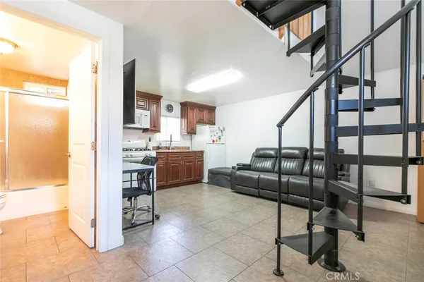 a kitchen with a refrigerator and a stove top oven