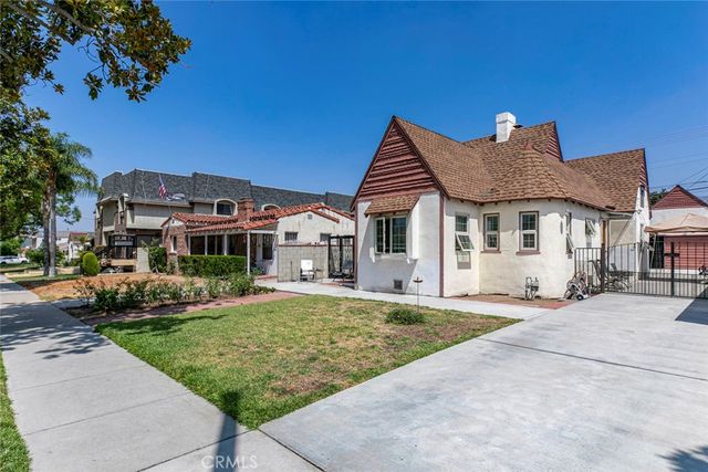 a front view of a house with a garden and yard