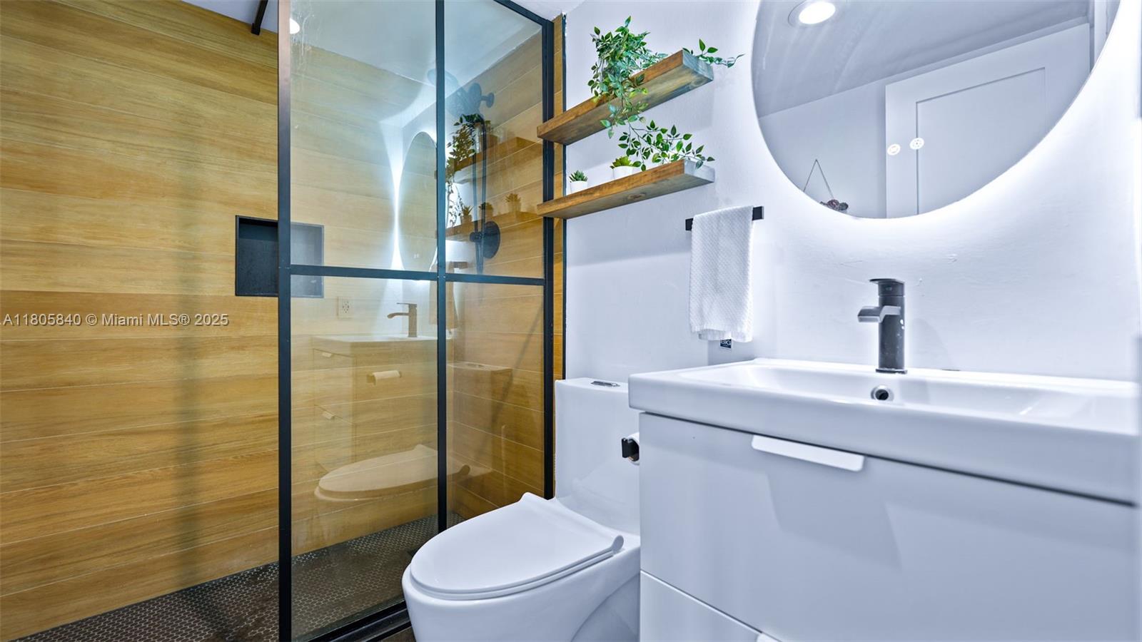 2750 Northeast 183rd Street, Unit 1610 Aventura, FL 33160 - Photo 13 of 16 a bathroom with a toilet sink and a mirror