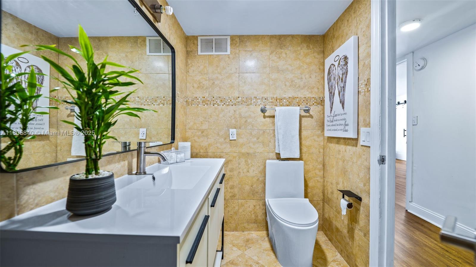 2750 Northeast 183rd Street, Unit 1610 Aventura, FL 33160 - Photo 15 of 16 a bathroom with a sink a toilet and shower