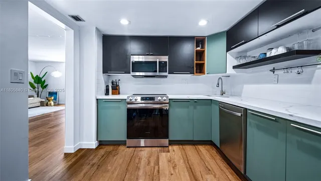 a kitchen with kitchen island a counter space a sink and appliances