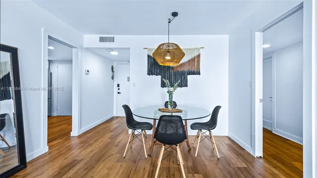 a view of a dining room with furniture wooden floor and chandelier