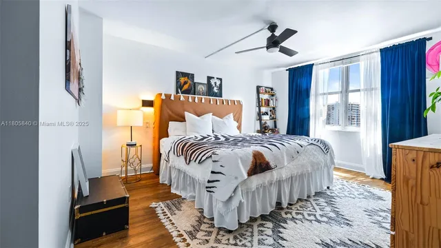 a bedroom with bed and wooden floor