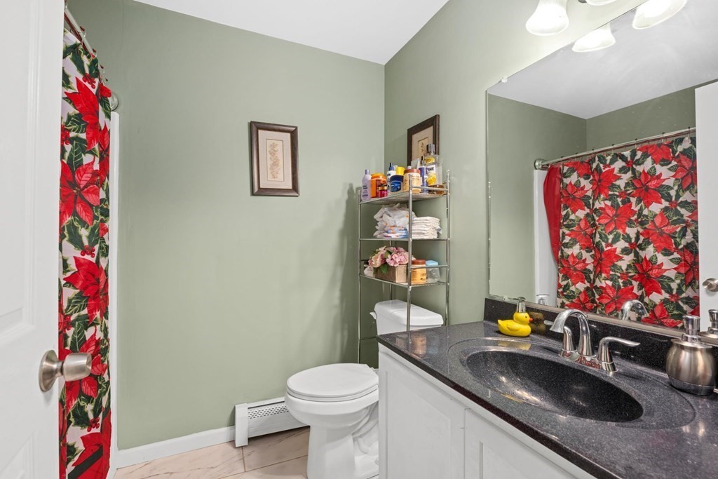 7 South Maxwell Court Worcester, MA 01607 - Photo 14 of 19 a bathroom with a sink mirror vanity and toilet