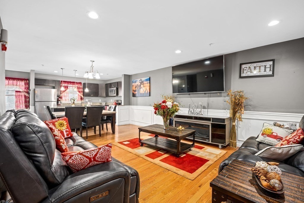 7 South Maxwell Court Worcester, MA 01607 - Photo 4 of 19 a living room with furniture gym equipment and a flat screen tv