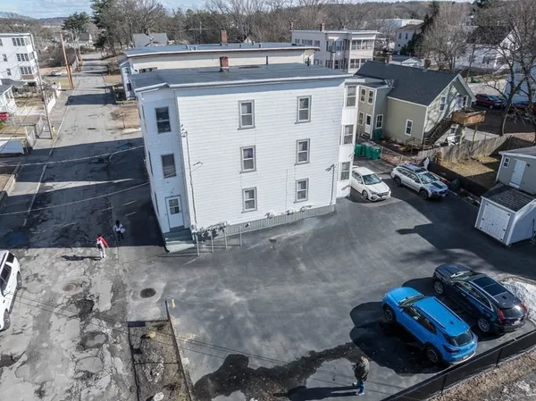 an aerial view of a house with parking space