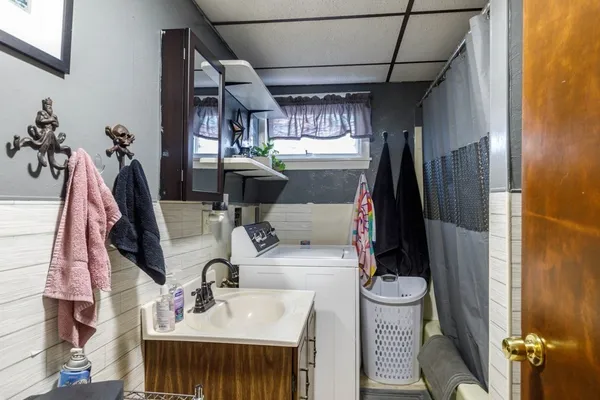 a kitchen with a refrigerator and a stove top oven