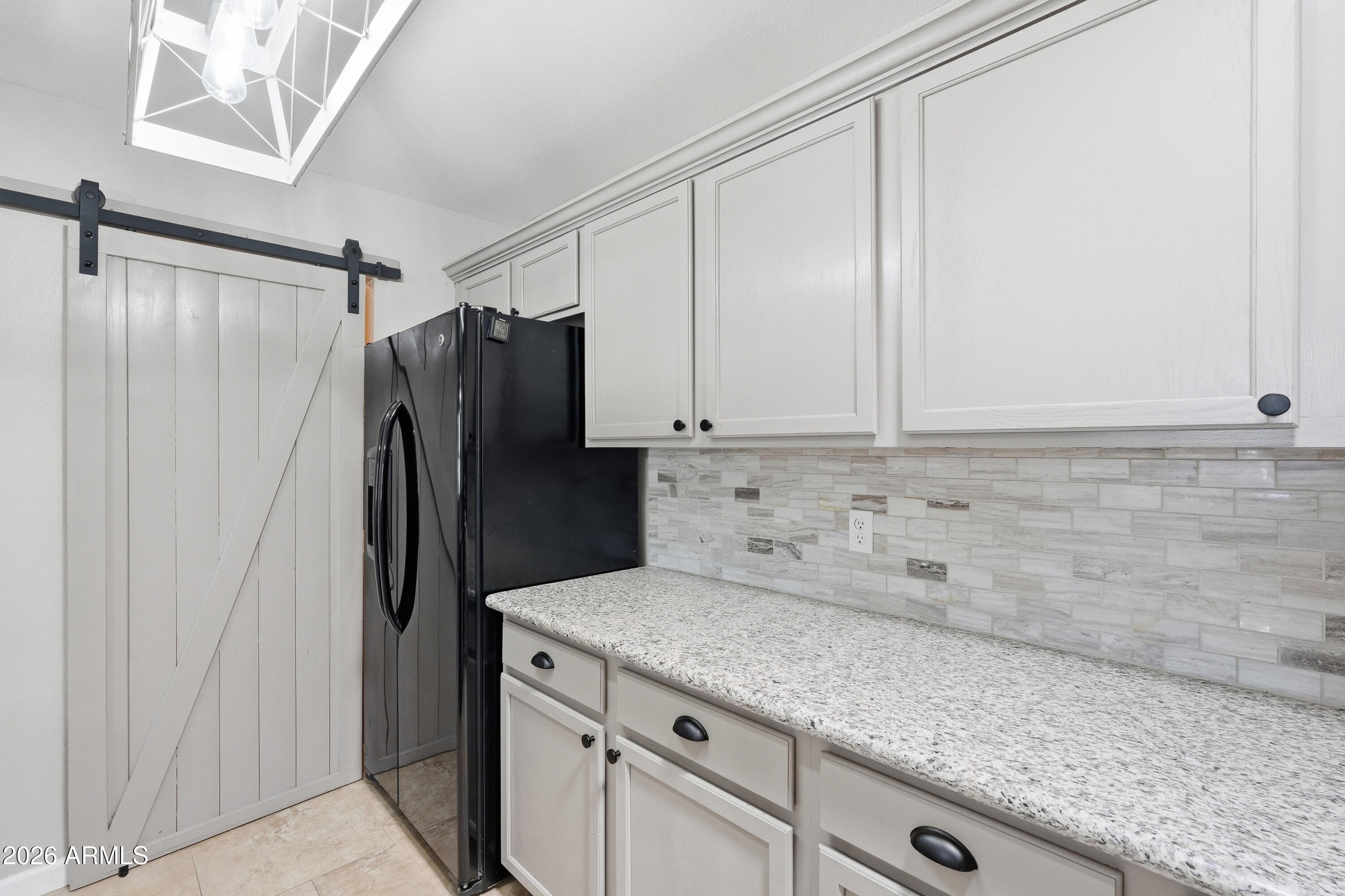 14300 West Bell Road, Unit 49 Surprise, AZ 85374 - Photo 7 of 19 a kitchen with stainless steel appliances granite countertop a refrigerator and a sink
