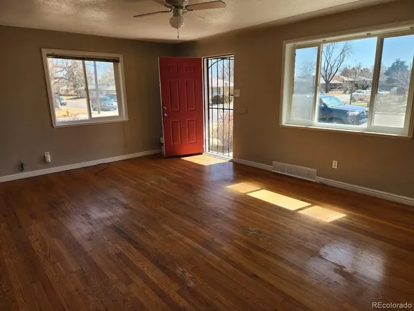 a view of empty room with wooden floor