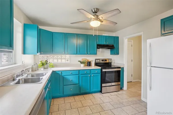 a kitchen with cabinets a sink and stainless steel appliances