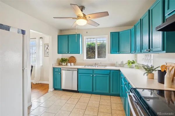 a kitchen with a refrigerator and a sink