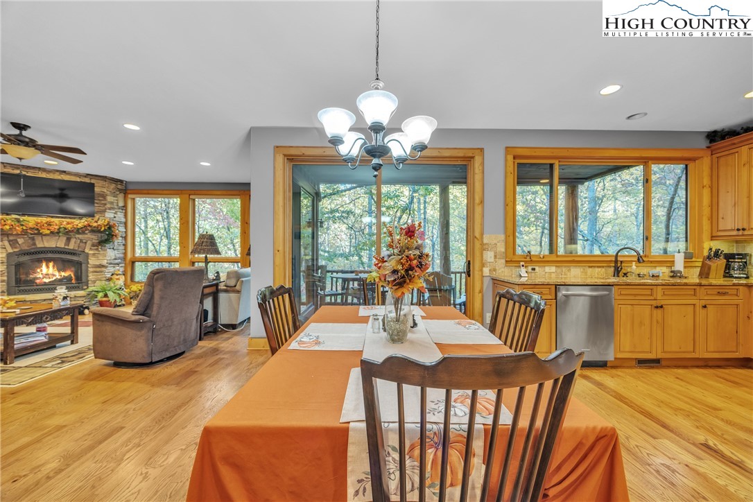 89 Springhouse Drive, Unit A4 Elk Park, NC 28622 - Photo 12 of 46 a view of a dining room with furniture large windows and a chandelier