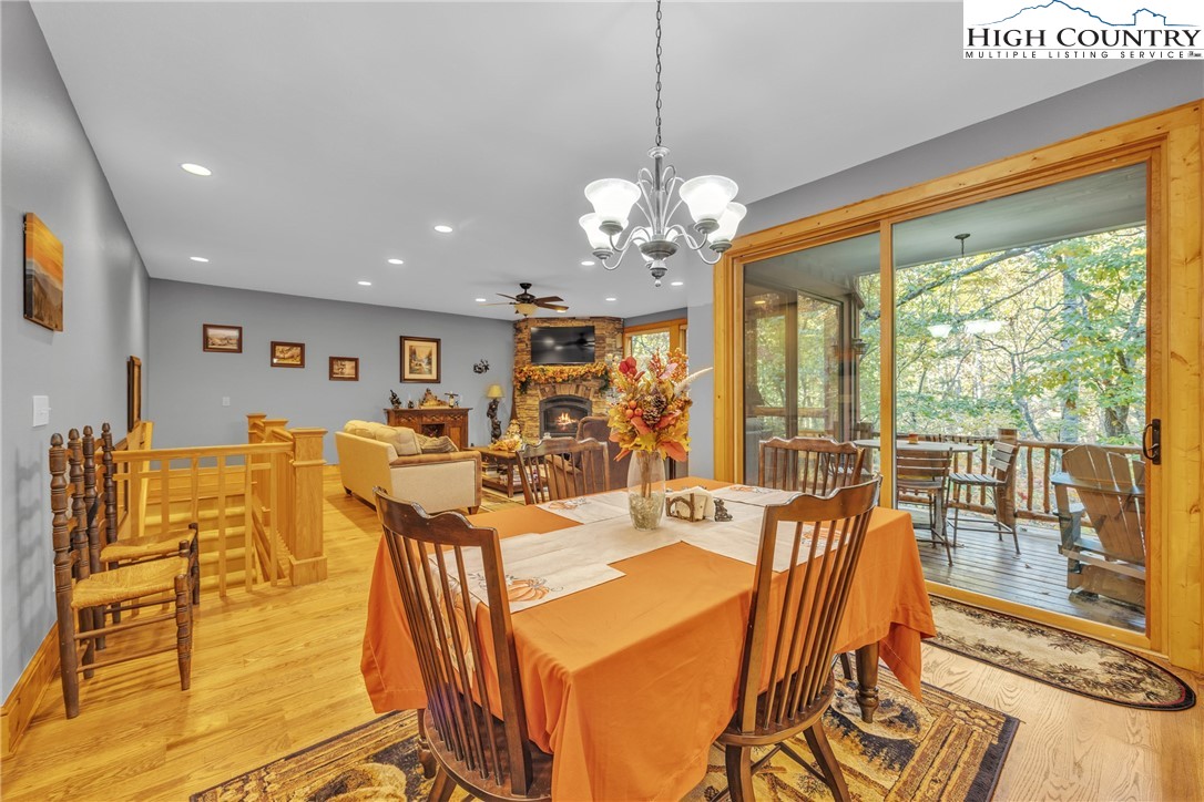 89 Springhouse Drive, Unit A4 Elk Park, NC 28622 - Photo 13 of 46 a view of a dining room with furniture wooden floor and chandelier