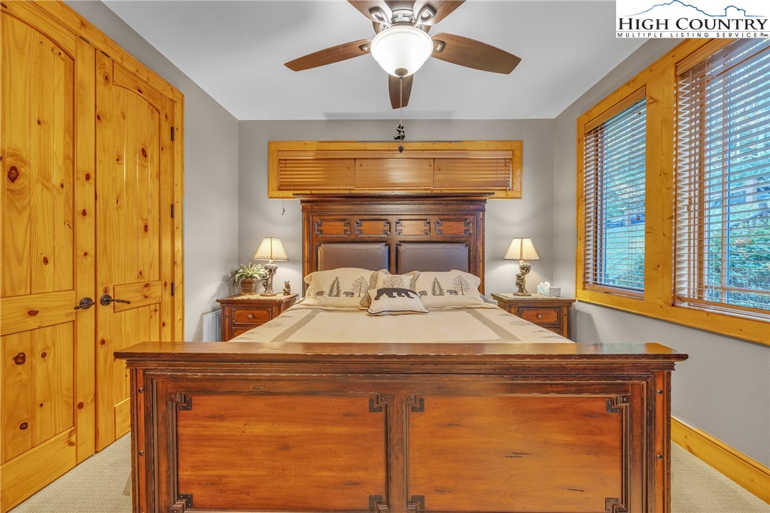 89 Springhouse Drive, Unit A4 Elk Park, NC 28622 - Photo 21 of 46 a bedroom with a bed and a chandelier