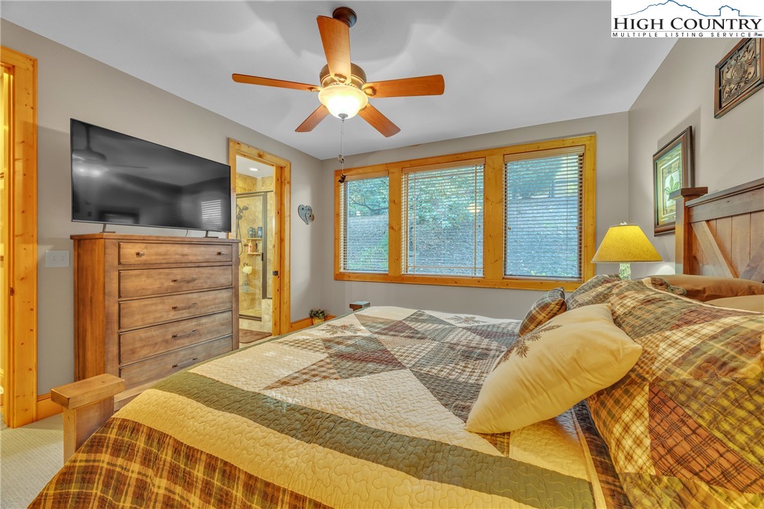 89 Springhouse Drive, Unit A4 Elk Park, NC 28622 - Photo 24 of 46 a bedroom with a bed and flat screen tv