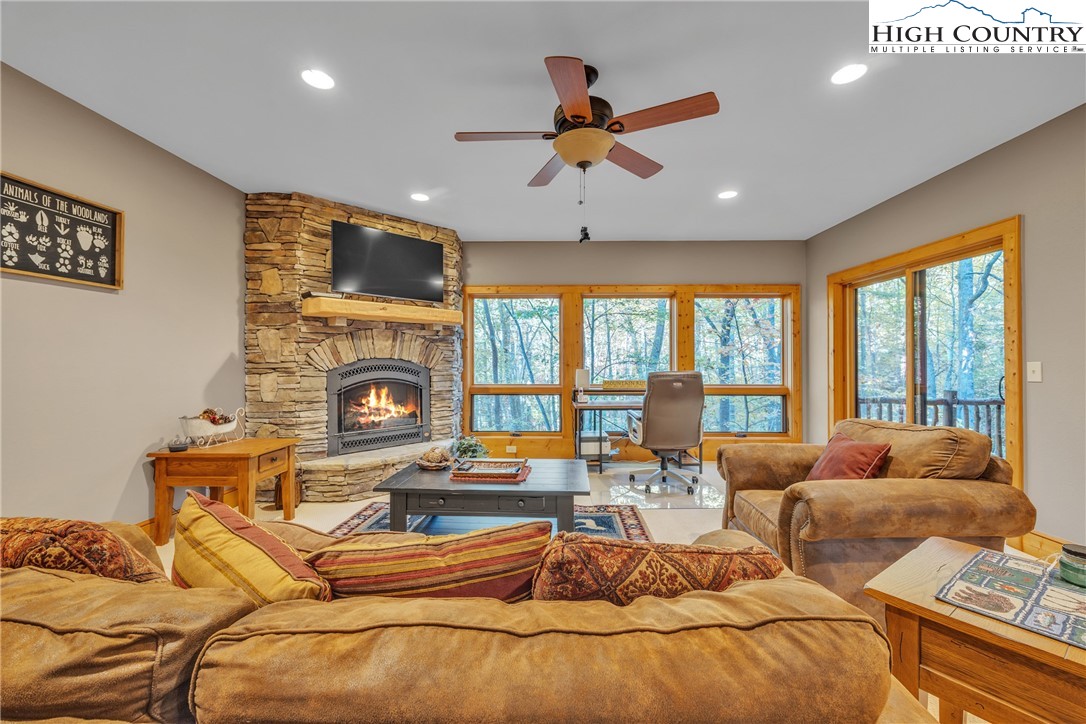 89 Springhouse Drive, Unit A4 Elk Park, NC 28622 - Photo 29 of 46 a living room with fireplace furniture and a large window