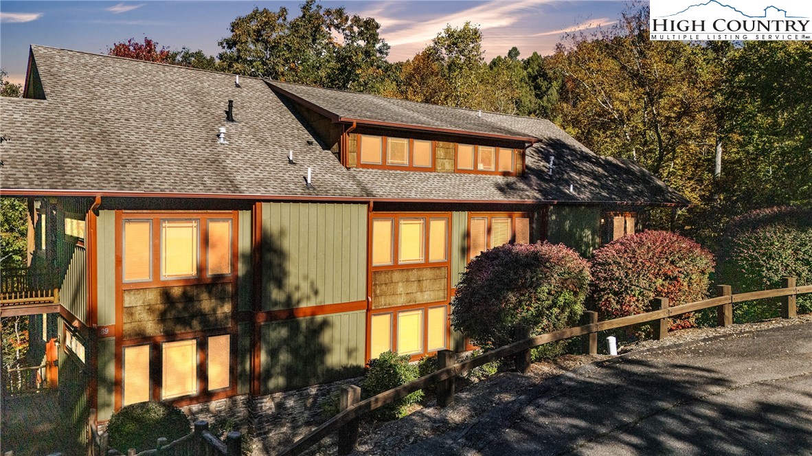 89 Springhouse Drive, Unit A4 Elk Park, NC 28622 - Photo 3 of 46 a view of a house with a large window and potted plants