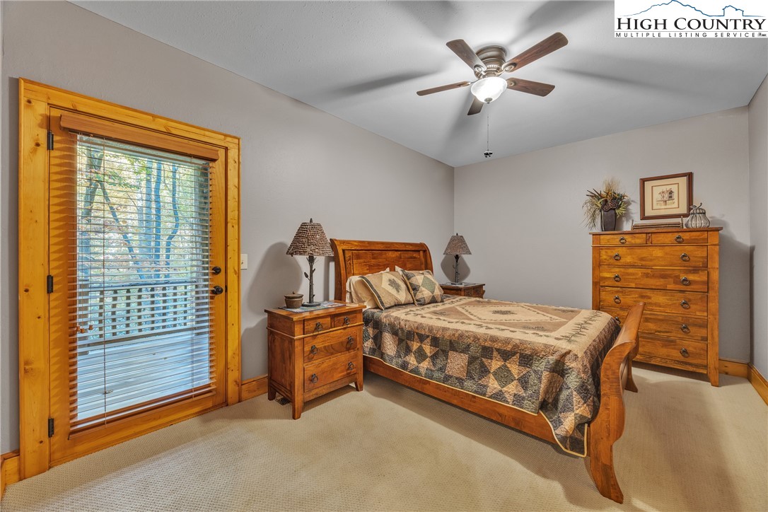89 Springhouse Drive, Unit A4 Elk Park, NC 28622 - Photo 31 of 46 a bedroom with a bed and ceiling fan