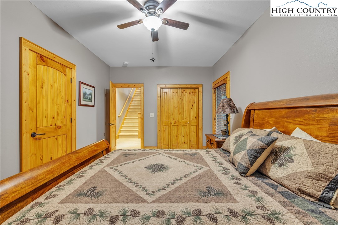 89 Springhouse Drive, Unit A4 Elk Park, NC 28622 - Photo 32 of 46 a bedroom with a large bed and wooden floor