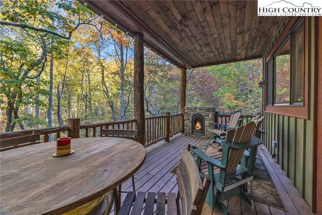89 Springhouse Drive, Unit A4 Elk Park, NC 28622 - Photo 35 of 46 a view of deck with table and chairs and wooden floor