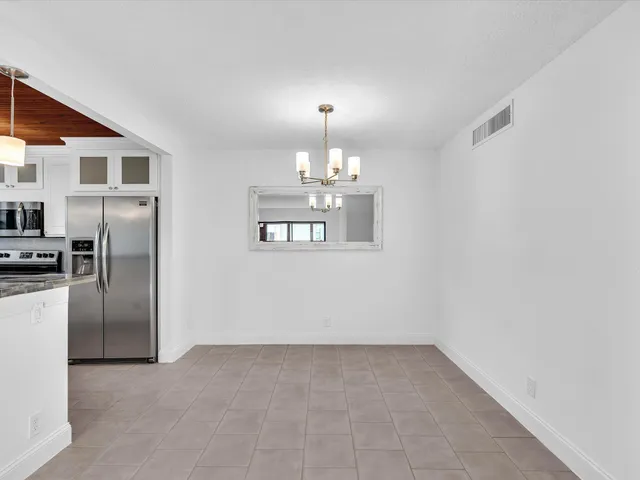 a view of a kitchen with a sink and refrigerator