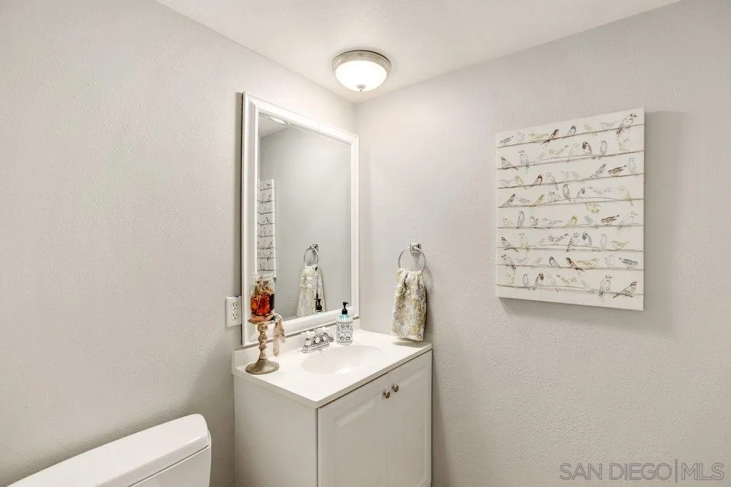 2807 Via Pajaro Carlsbad, CA 92010 - Photo 14 of 26 a bathroom with a sink vanity and a mirror