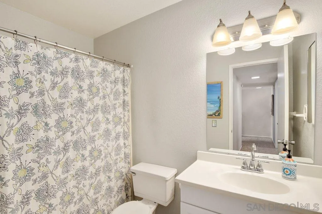 2807 Via Pajaro Carlsbad, CA 92010 - Photo 19 of 26 a bathroom with a sink a toilet and a mirror