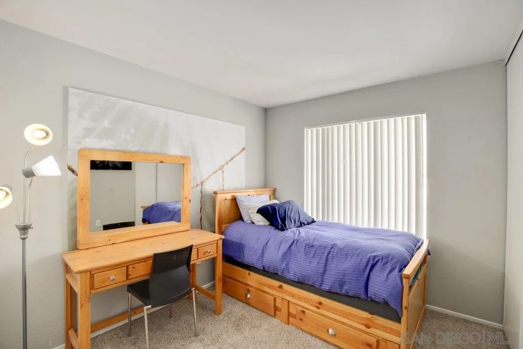 2807 Via Pajaro Carlsbad, CA 92010 - Photo 20 of 26 a bedroom with a bed and wooden floor