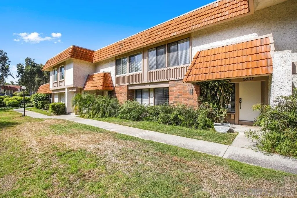 2807 Via Pajaro Carlsbad, CA 92010 - Photo 26 of 26 a front view of a house with a yard and potted plants