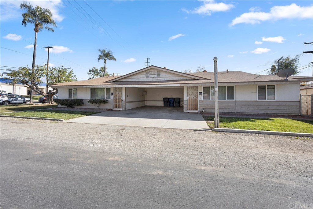 3444 Russell Street Riverside, CA 92501 - Photo 1 of 1 a front view of a house with a garden and yard