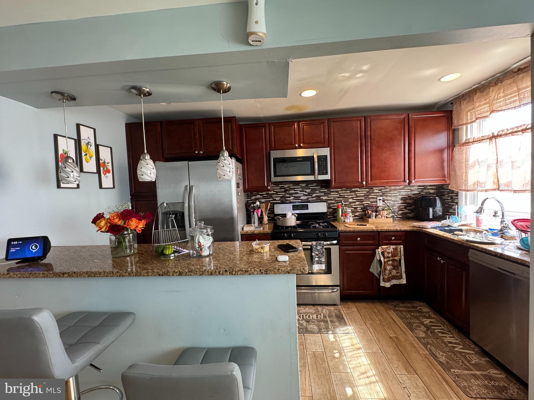 1234 Greeby Street Philadelphia, PA 19111 - Photo 6 of 18 a kitchen with stainless steel appliances granite countertop a refrigerator sink and stove