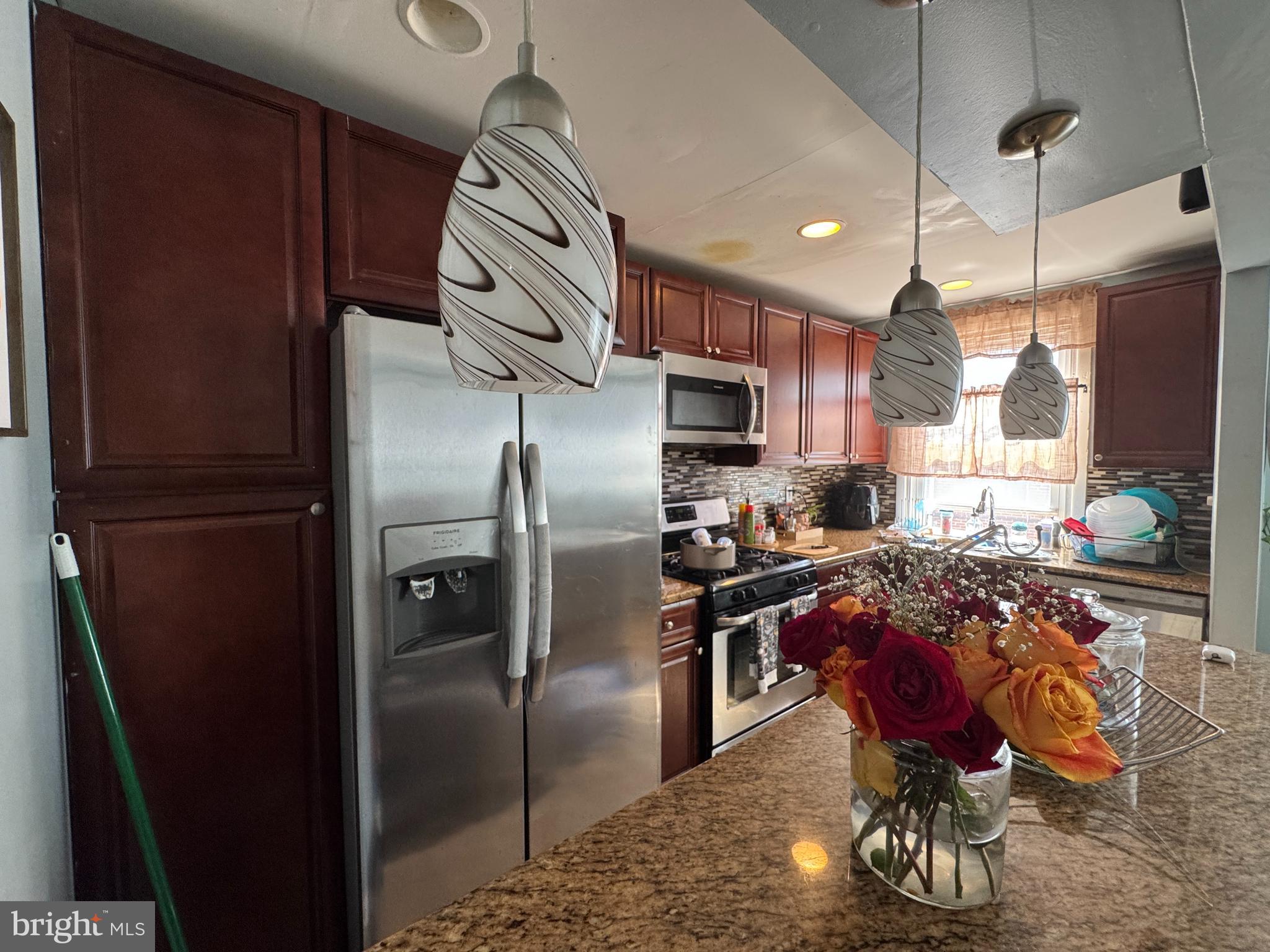 1234 Greeby Street Philadelphia, PA 19111 - Photo 8 of 18 a kitchen with stainless steel appliances granite countertop a refrigerator a stove a sink and a dining table