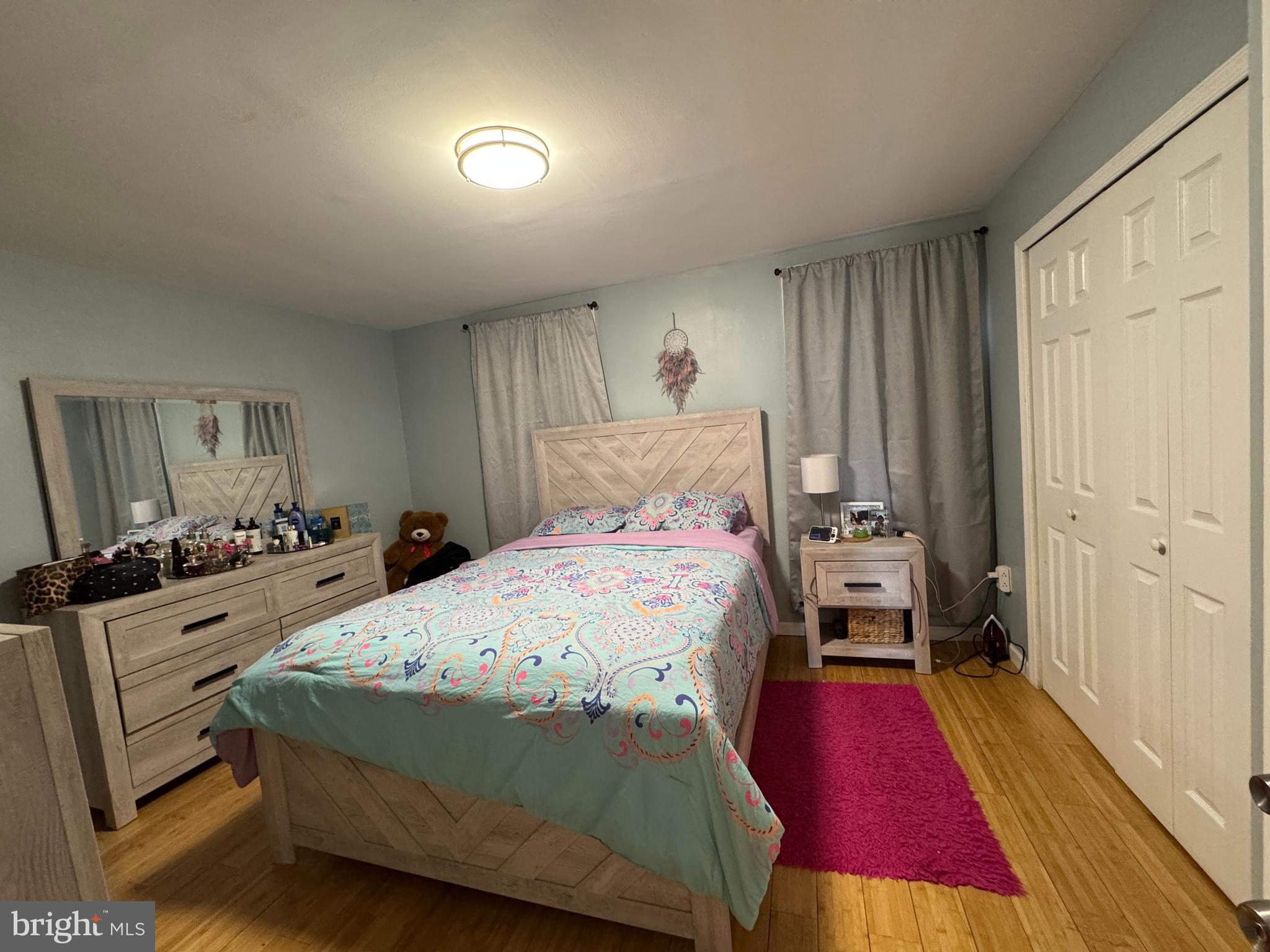 1234 Greeby Street Philadelphia, PA 19111 - Photo 9 of 18 a bedroom with a bed and wooden floor