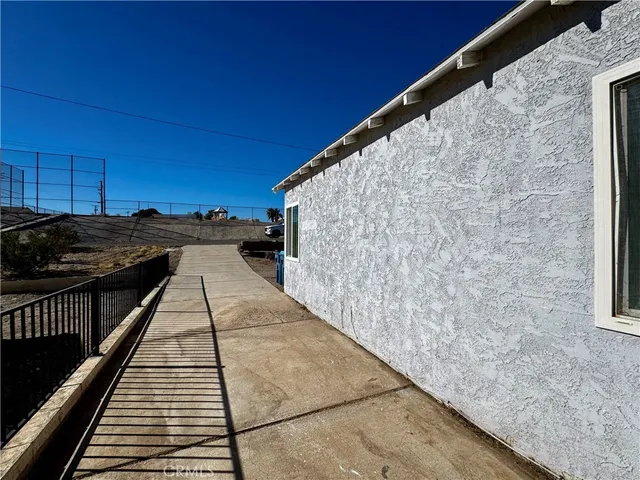 a view of balcony with wooden floor and fence